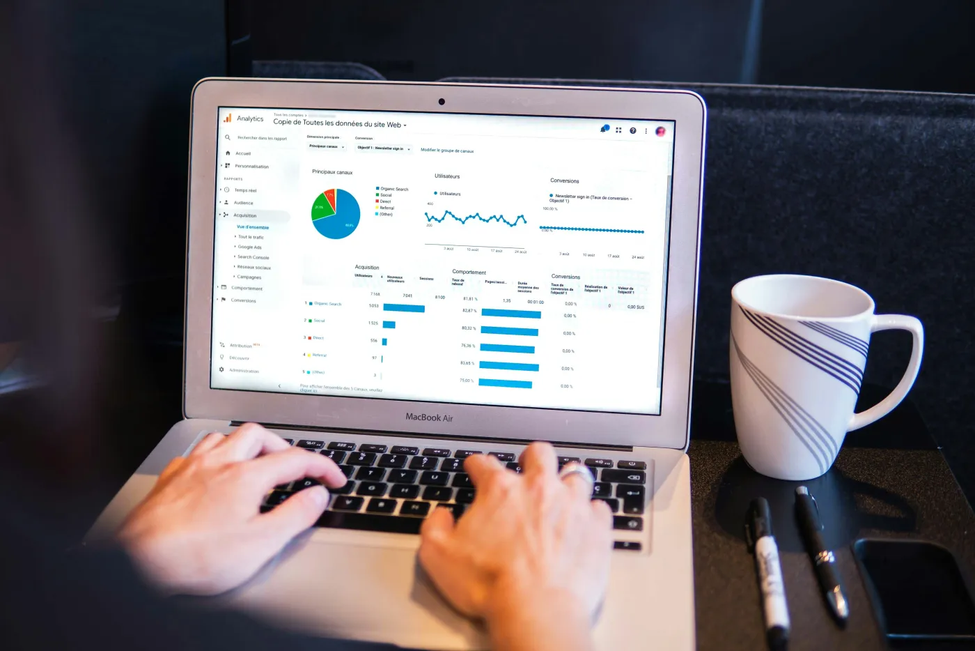 SEO analyst reviewing competitor backlink profiles and referring domains on a laptop